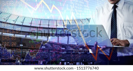 Mid-section of business man using a laptop against stocks and shares