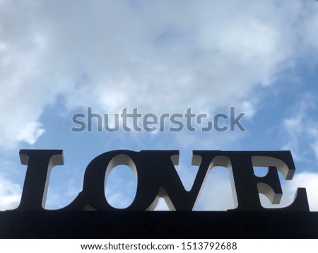 The inscription "love" against the sky. Tablet with the word love. Concept: Valentine's Day, declaration of love, love of life.