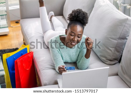 Young beautiful woman happy for finding shopping items for sale online. Online shopping concept. Happy woman doing online shopping at home