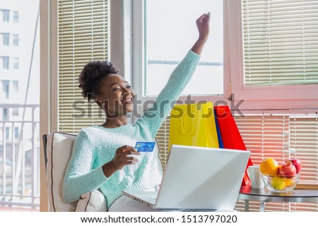 Young beautiful woman happy for finding shopping items for sale online. Beautiful girl using laptop computer for online shopping at home