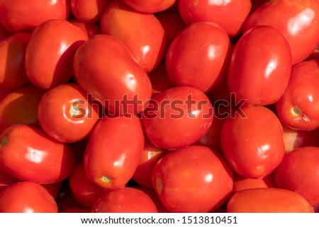 Tomato vegetables stacked on a surface as background