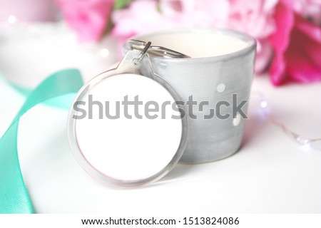 Mockup round keychain with flowers and ornaments. Empty plain keyring souvenir holder template. 