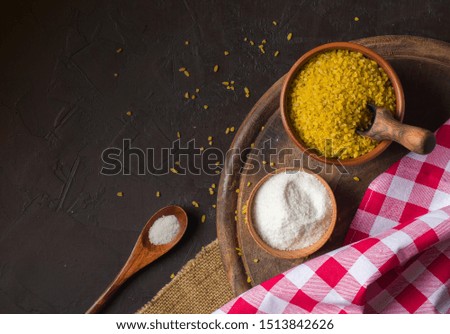 Bulgur on a dark background. wholesome organic food for breakfast or diet. Natural fabrics and earthenware. Copy space.