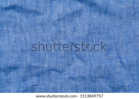 Crumpled light blue linen fabric background, close up