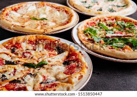Traditional Italian pizza on a dark background top view copy space.