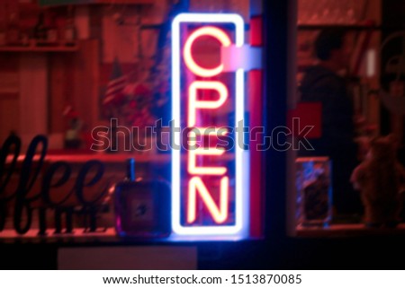 Abstract blurred and bokeh image of Neon Sign Open signage Light Bar Restaurant Shop. 