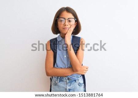 Beautiful student child girl wearing backpack and glasses over isolated white background thinking looking tired and bored with depression problems with crossed arms.