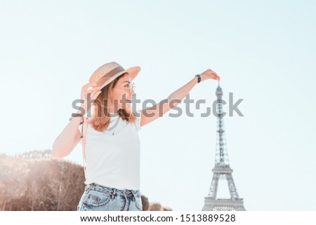 Happy asian woman traveler posing at Mars Field at the background of majestic Eiffel tower. Tourism and lifestyle in France and Paris. Vacation in Europe.