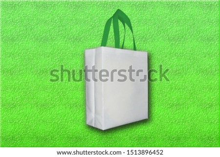 Box Type Bag, White Bag on Green Background. Best Quality Nonwoven fabric bags. These bags is made of 50 micron can 70% recycled materials.