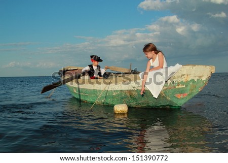 Beautiful little kids play pirates/Little boy dressed as a pirate stole the little lady in a white dress and took on an old boat