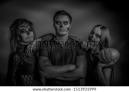 Black and white portrait of young people painted like zombies. Halloween makeup