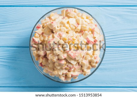 Traditional Russian New Year salad with crab sticks , corn , eggs and mayonnaise