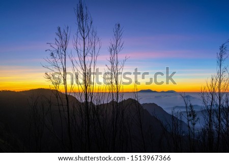 Travel concept of a journey to Bromo mountain in Indonesia - well knowd for landscape beauty and active volcanoes. An Asian male tourist standing relax on the view point