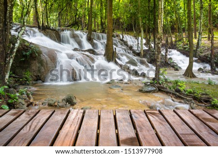 Pha Tat Waterfall at Kanchanaburi, Thailand with wooden plank bridge