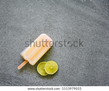 yellow fruity with lemon  sliced  ice cream stick on with marble background.Copy space for your text