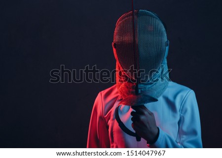 Fencer woman in mask profile portrait with fencing sword, rapier, epee. Royalty-Free Stock Photo #1514047967