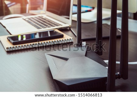 Dual Band Router or Wireless AC router with a computer laptop in home office background . Computers and Router wireless broadband Accessories concept     