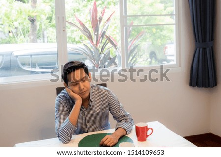 Asian family, father awaiting breakfast from mother in dining room, happy family concept