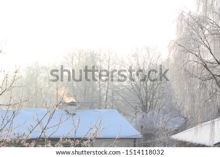Smoking Pipe On Roof In A Cold Winter Day. Winter Smoke Comes From The Chimney At Home. Stock photo.