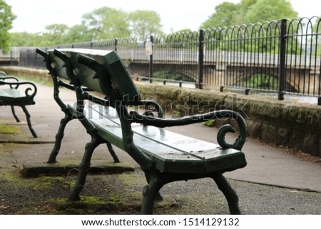 A wet bench beside a river in Otley, Yorkshire. 