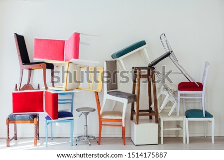 lots of multicolored chairs in the interior of the white room