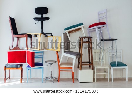 lots of multicolored chairs in the interior of the white room