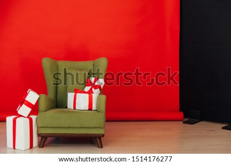 green vintage chair with gifts in the interior of the red room