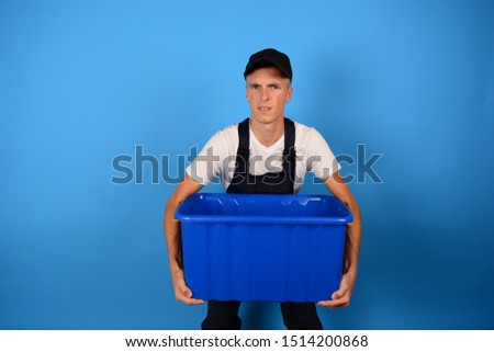 delivery man with a heavy box on a blue background