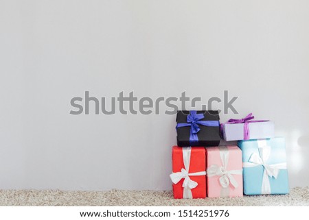 lots of different holiday gifts on a grey background