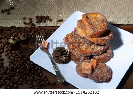 Brazilian french toast, traditional sweet in Christmas dinner.Rabanada brasileira.Torrijas, traditional in spanish holy week. White dish background. Seen from above.Vertical. Royalty-Free Stock Photo #1514252132