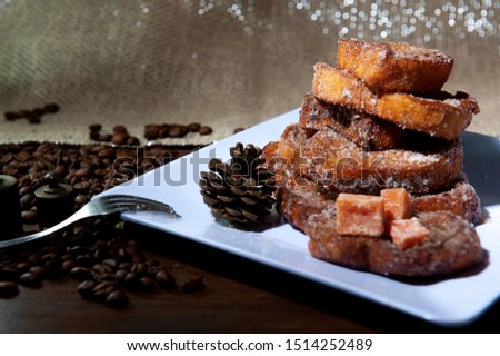 Sweet bread, milk, egg, known as Brazilian french toast. Rabanada brasileira.Traditional at Christmas dinner. Torrijas, traditional in spanish holy week. White background. Seen up close.Horizontal. Royalty-Free Stock Photo #1514252489