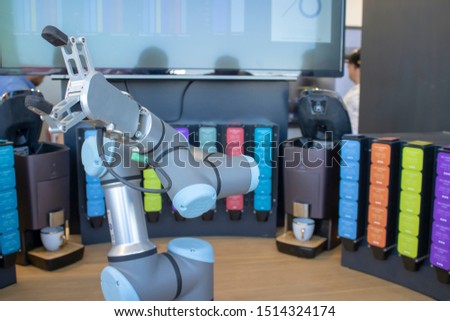 Robotic arm close-up. Background in various colors. While robotic arm cups.