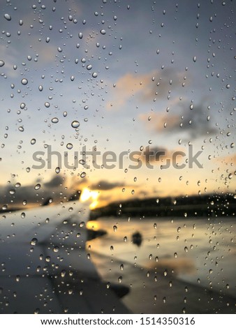 The view of morning sun rise from the plane window after rain, with blurred background.
