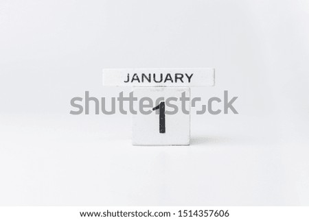 Business and design concept - geometric floating wooden cube on white background. 1 January.