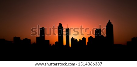 A view of downtown Atlanta in silhouette during sunset - taken from Jackson Street Bridge