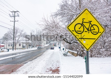 Slush and Sleet of Snow on roads nest to the Bicycle Crossing Sign after winter storm in Virginia. 