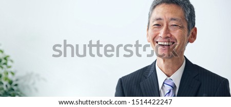 Smiling middle aged asian businessman.