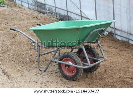 Two-wheeled wheelbarrow ( hand cart ) in a green house