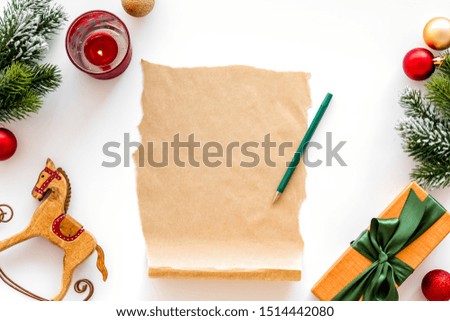Letter to Santa Claus concept. Paper on white background with New Year decoration top view mockup space for text