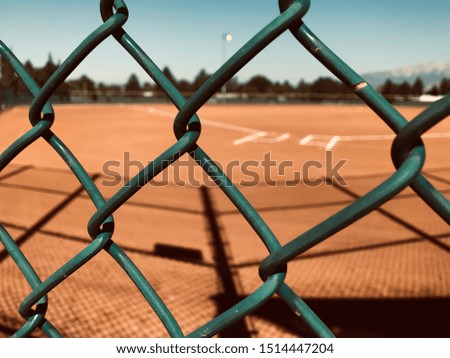 A Baseball Field Seen Through a Chain Link Fence.