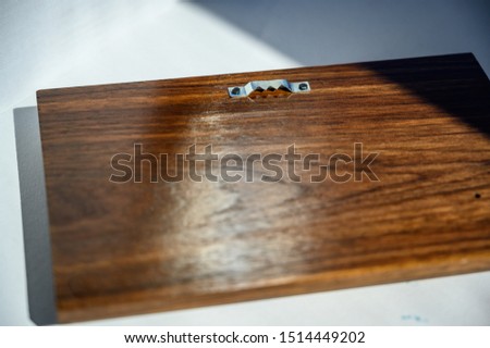 Saw tooth wall hanging hardware on walnut wood