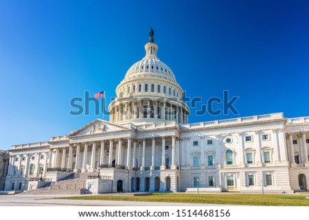 US Capitol over blue sky Royalty-Free Stock Photo #1514468156