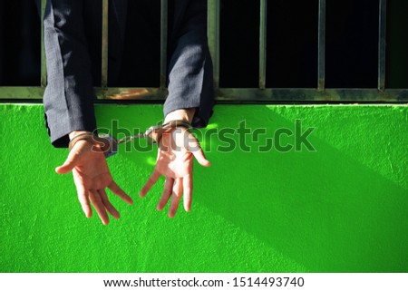 close up of hand in jail background