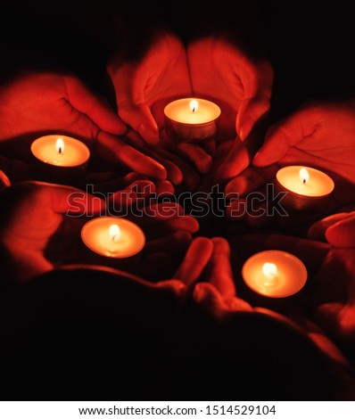 prayer with candles in hands
