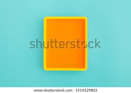 Yellow photo frame with round corners on blue background. Mockup
