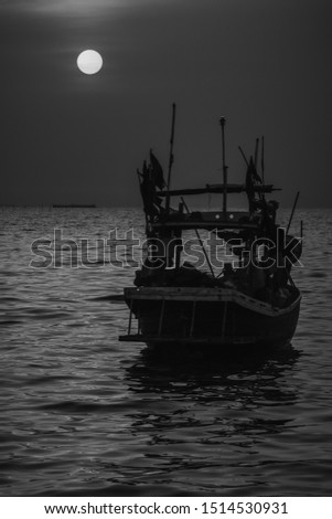 Black and white picture, fishing boat in the evening sunset at Bang Saen