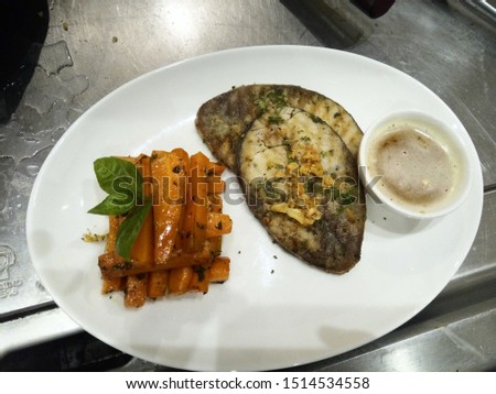 grilled fish prepared by a chef and this picture was taken inside hotel kitchen