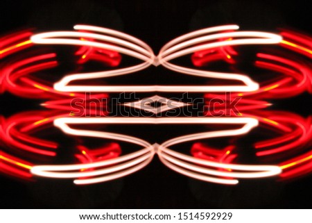 Abstract light trails in colors forming elliptical shapes on black background