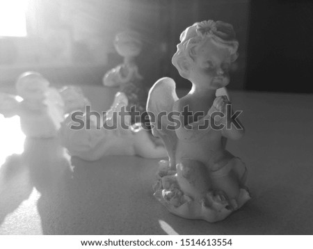little praying angel with more angels in the background