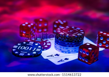 Casino abstract photo. Poker game on red background.  Theme of gambling. Royalty-Free Stock Photo #1514613722